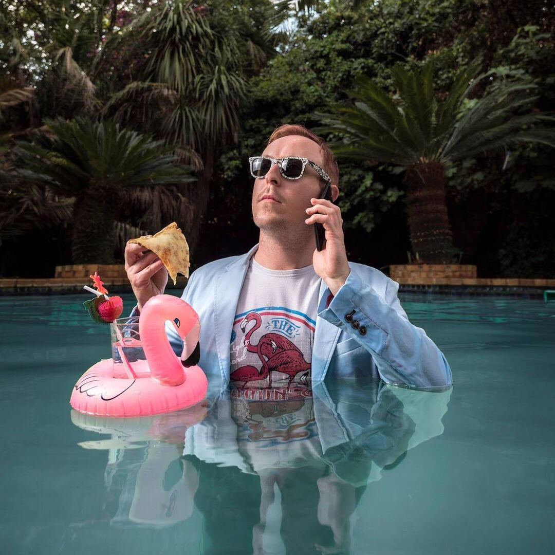 Craig Rawlins-Wilson in a baby blue suit in a swimming pool